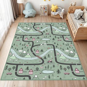 May include: A green and blue play rug with a road map design. The rug features roads, houses, mountains, trees, and a lake. The design includes a tractor, bus, and hot air balloon. The rug is designed for children's play areas.