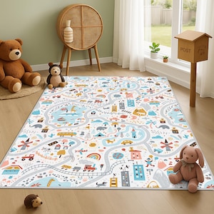 May include: A white play mat with a colourful city and road design. The mat features roads, buildings, vehicles, and natural elements like mountains and rainbows. The mat is designed for children's play and learning.