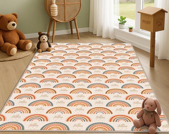 May include: A rectangular area rug with a repeating pattern of colorful rainbows and clouds. The rug features a cream-colored background with orange, blue, and brown rainbows. The rug is placed on a wooden floor in a room with a window and a wooden cabinet.