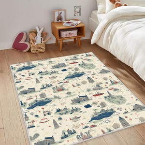 May include: A rectangular area rug with a cream background and a repeating pattern of illustrated landmarks, boats, and water features in blue, red, and green. The rug is placed on a wooden floor in a child's bedroom.