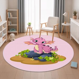 May include: A round pink rug featuring a cartoon dragon. The dragon is purple with green eyes, sitting on a dark blue rock with green foliage. The rug is in a room with a window and a chair.