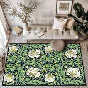 May include: A rectangular area rug with a floral pattern. The rug features large white flowers with green leaves and yellow accents against a black background. The rug is placed in a living room setting.