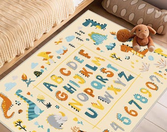 May include: A rectangular beige rug with a colorful dinosaur and alphabet design. The rug features the letters A through Z and numbers 1 through 9. The dinosaurs are in shades of blue, orange, and yellow. The rug is designed for a child's room.
