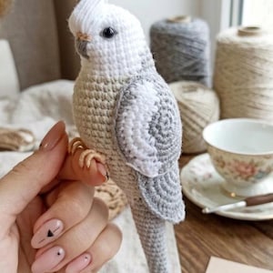 May include: A set of three ceramic mugs with a speckled, matte finish in cream, light grey, and dark grey. Each mug has a simple, minimalist design and a rounded handle.