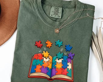 T-Shirt für Leseförderkräfte in Wohlfühlfarben, T-Shirt mit Rätselbuch für Lesespezialisten, Geschenk für Leselehrer, T-Shirt für Sonderpädagogen