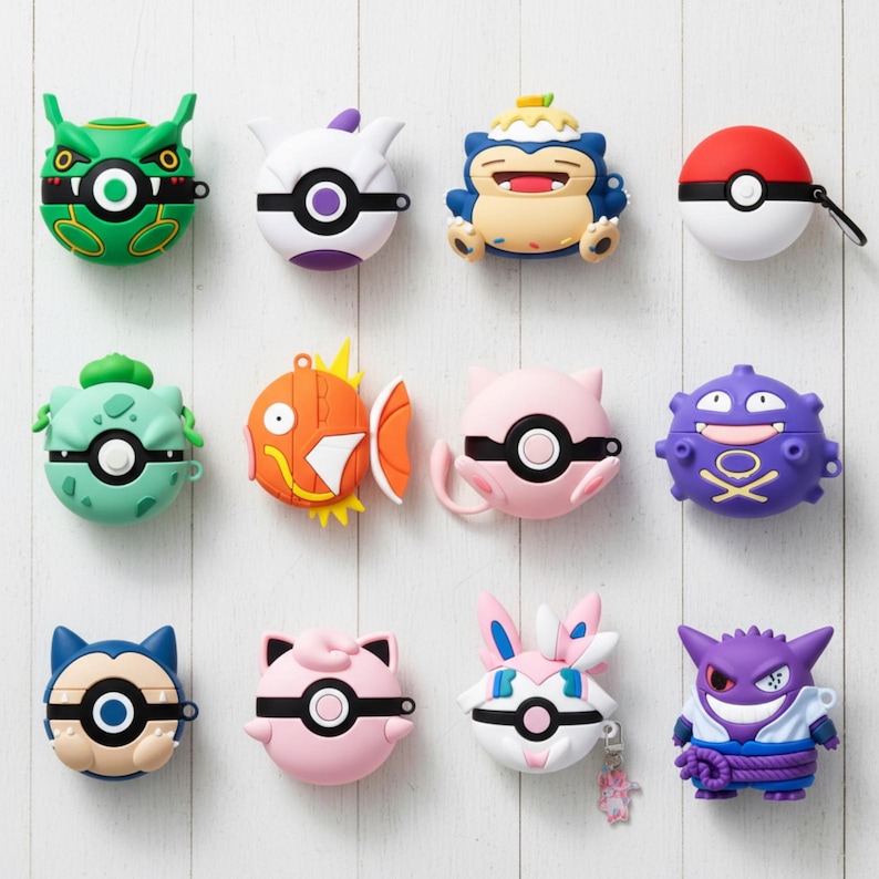 May include: A collection of colorful, character-themed AirPod cases. The cases feature various designs, including a green monster, a white and purple creature, a blue and beige character, a red and white Pok&eacute; Ball, a green plant-like creature, an orange fish, a pink cat-like character, and a purple monster.
