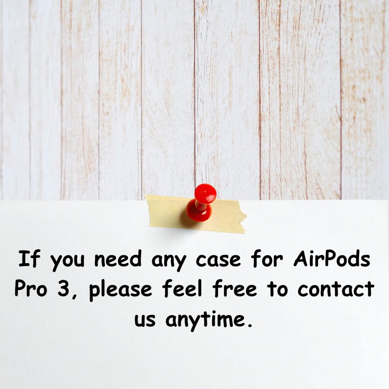 May include: A white note with text about AirPods Pro 3 cases, secured with a red push pin and tan tape, against a light wood grain background.