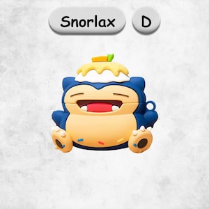 May include: A silicone protective case for wireless earbuds shaped like the character Snorlax, featuring a blue and beige body, a wide smiling mouth, and a yellow dessert topping with a green leaf. The text Snorlax and the letter D are visible.