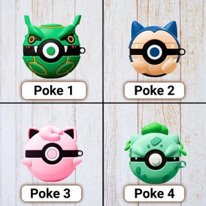 May include: Four colorful, character-themed cases for wireless earbuds. The cases are green, blue, pink, and green, each with a unique design and the text "Poke" followed by a number. The cases are on a light wood-grain surface.