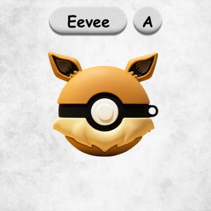 May include: A round, tan and cream-colored silicone protective case shaped like a Pokeball with Eevee-inspired ears. The case features a central white button, a black horizontal band, and the text Eevee A displayed above the object in a clear font.