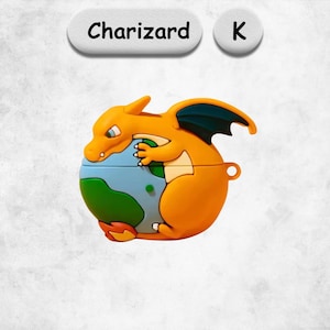 May include: A silicone protective case for wireless earbuds featuring a three-dimensional orange Charizard character hugging a blue and green globe. The case includes a small side loop and is labeled with the text Charizard and the letter K above.