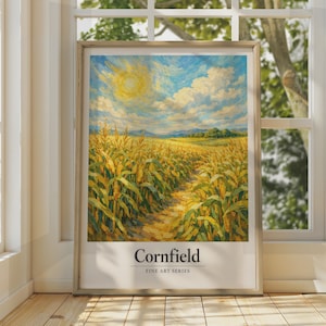 May include: A framed art print featuring an impressionistic painting of a golden cornfield under a bright sun and blue sky with white clouds. The text "Cornfield" and "FINE ART SERIES" is printed in black at the bottom of the white border.