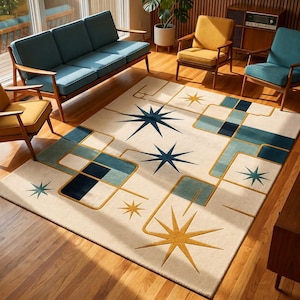 May include: A rectangular area rug featuring a cream-coloured background with a geometric pattern of dark blue, light blue, and mustard yellow shapes. The design includes several multi-pointed starburst motifs and interconnected linear paths.