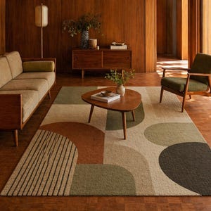 May include: A mid-century modern living room featuring a beige sofa, a wooden coffee table, and a patterned rug with brown, green, and beige geometric shapes. The room has wooden paneling and a green armchair.