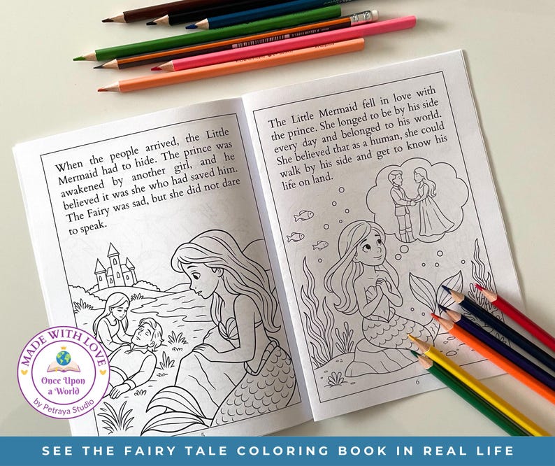 May include: Open coloring book with illustrations from "The Little Mermaid" fairy tale. The pages are open, showing line drawings of Ariel and Prince Eric. Colored pencils in various colors are scattered around the book. Text on the bottom says "SEE THE FAIRY TALE COLORING BOOK IN REAL LIFE."