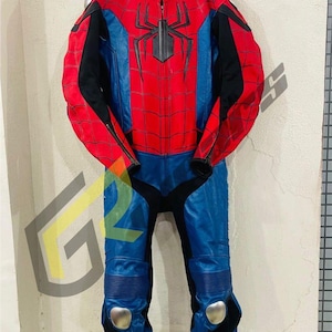 May include: A red, blue, and black motorcycle racing suit with a spider web design. The suit has a black spider emblem on the chest and knee pads. The suit is hanging on a black hanger.