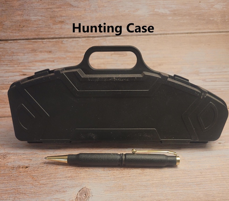 May include: Black hard plastic case with a handle, labeled "Hunting Case". A black pen with a gold tip is lying in front of the case.