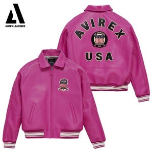 May include: A vibrant pink leather jacket with a collared neckline and a zip-up front. The jacket features a patch on the chest and the back with the text "AVIREX" and "USA". The jacket has white and red striped detailing on the cuffs and hem.