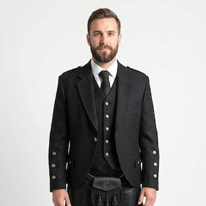 May include: A formal black wool jacket, waistcoat, and tie ensemble. The jacket features silver buttons and epaulettes. The waistcoat has silver buttons. A black leather sporran with tassels is worn at the waist. Suitable for formal events.