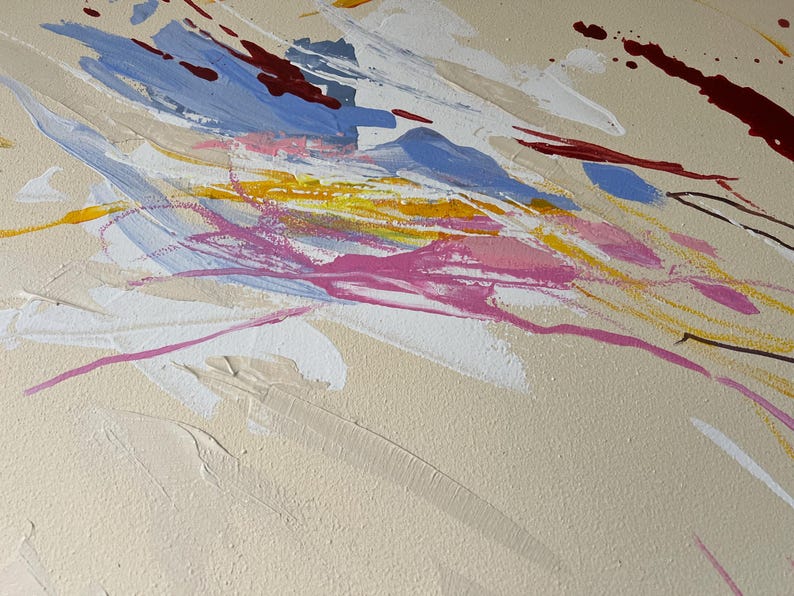 May include: Abstract painting with a beige background and dynamic brushstrokes in shades of blue, pink, yellow, white, and maroon. The artwork features a textured surface with visible paint layers, creating a sense of depth and movement. The composition is a modern, expressive piece.