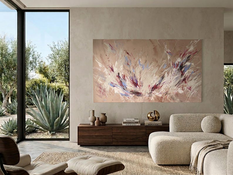 May include: An abstract painting with a beige background and dynamic brushstrokes in white, purple, and blue hues. The artwork hangs above a dark wood cabinet with decorative vases and books. A modern living room setting.