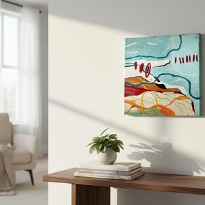 May include: Abstract landscape painting on canvas. The artwork features a light blue sky with white and teal lines, red circles and dashes. The lower portion depicts a colorful landscape with orange, red, and yellow hues.