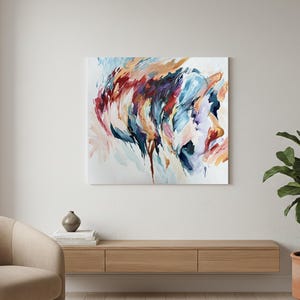 May include: Abstract painting on canvas featuring a profile portrait. The artwork uses a palette of blues, reds, oranges, and whites, with visible brushstrokes creating a dynamic and expressive composition. The painting is displayed on a white wall.