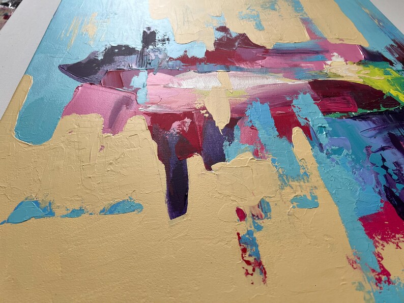 May include: Abstract painting with a palette of gold, light blue, pink, and deep red. The artwork features thick brushstrokes and textured paint, creating a dynamic and expressive composition. The painting's style is modern and bold.