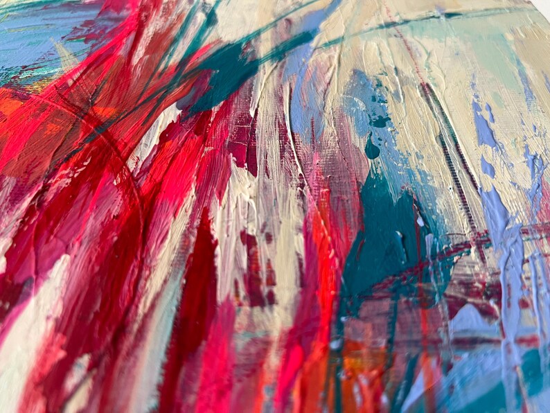 May include: Abstract painting with thick brushstrokes in shades of red, pink, teal, and blue on a cream-colored background. The textured paint creates a dynamic and expressive artwork.