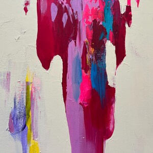May include: Abstract artwork featuring a cream backdrop with vibrant strokes of magenta, pink, blue, yellow, and purple. The paint drips and blends, creating a dynamic and textured piece.