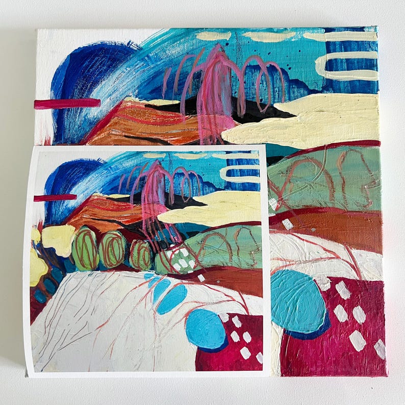 May include: An abstract painting on canvas featuring a layered landscape composition with vibrant shades of blue, magenta, cream, and earthy brown. The artwork incorporates textured brushstrokes, linear markings, and a smaller print overlay.
