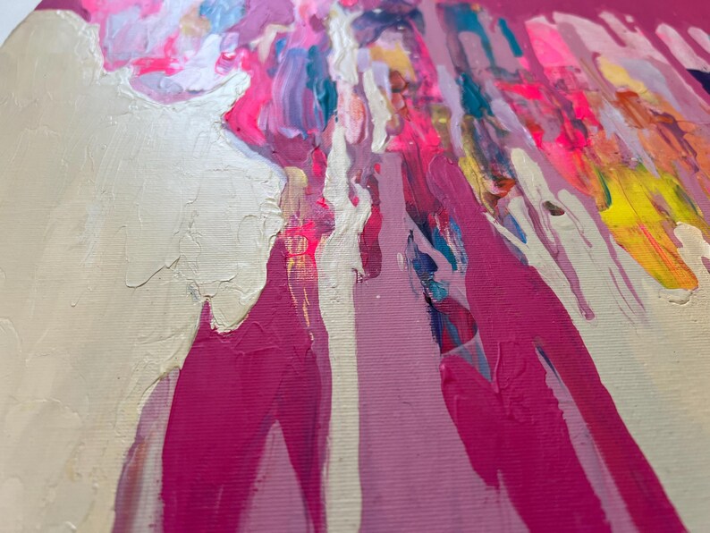 May include: Abstract painting with a textured, off-white background and vibrant splashes of pink, yellow, and blue. The artwork features a layered effect with visible brushstrokes, creating a dynamic and colorful composition.