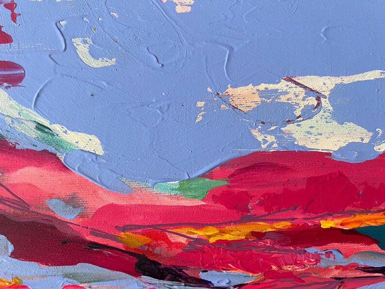 May include: Abstract painting with thick brushstrokes. The artwork features a sky-blue background with textured white and yellow accents. Bold red and pink strokes create a landscape effect, with hints of green and yellow.