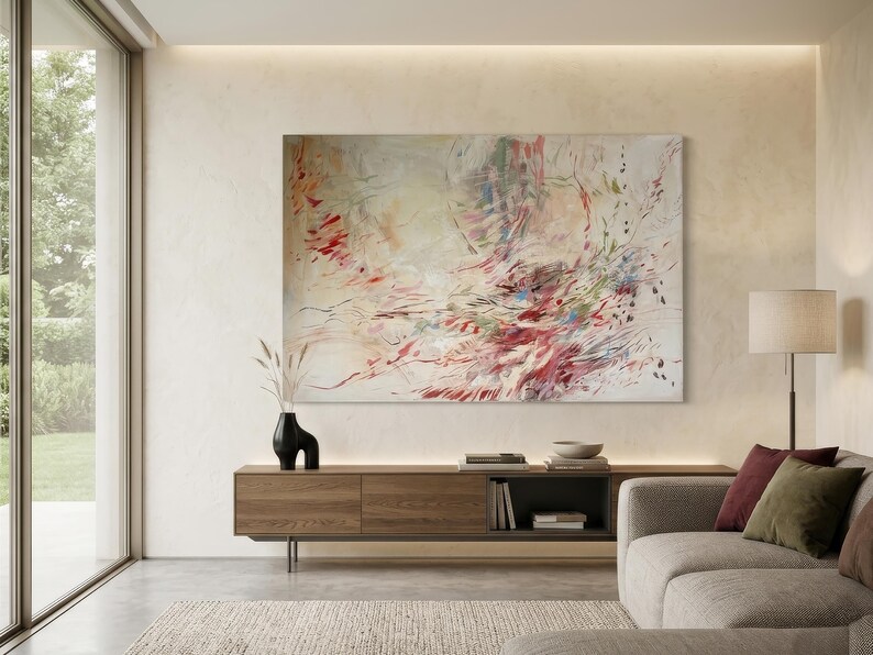 May include: A large rectangular abstract painting featuring a dynamic composition of sweeping brushstrokes in shades of crimson, soft pink, muted green, and blue against a creamy off-white background, displayed on a light-colored wall.