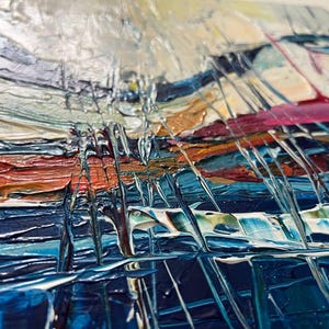 May include: Abstract painting with thick brushstrokes in shades of blue, orange, white, and pink. The textured surface creates a sense of depth and movement. The artwork appears to be an original piece, showcasing a modern art style.