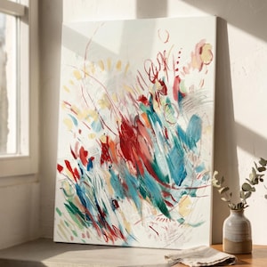 May include: A rectangular canvas painting featuring an abstract composition with energetic brushstrokes in vibrant red, deep teal, soft yellow, and white. The artwork displays layered paint textures, thin linear markings, and circular shapes across the surface.