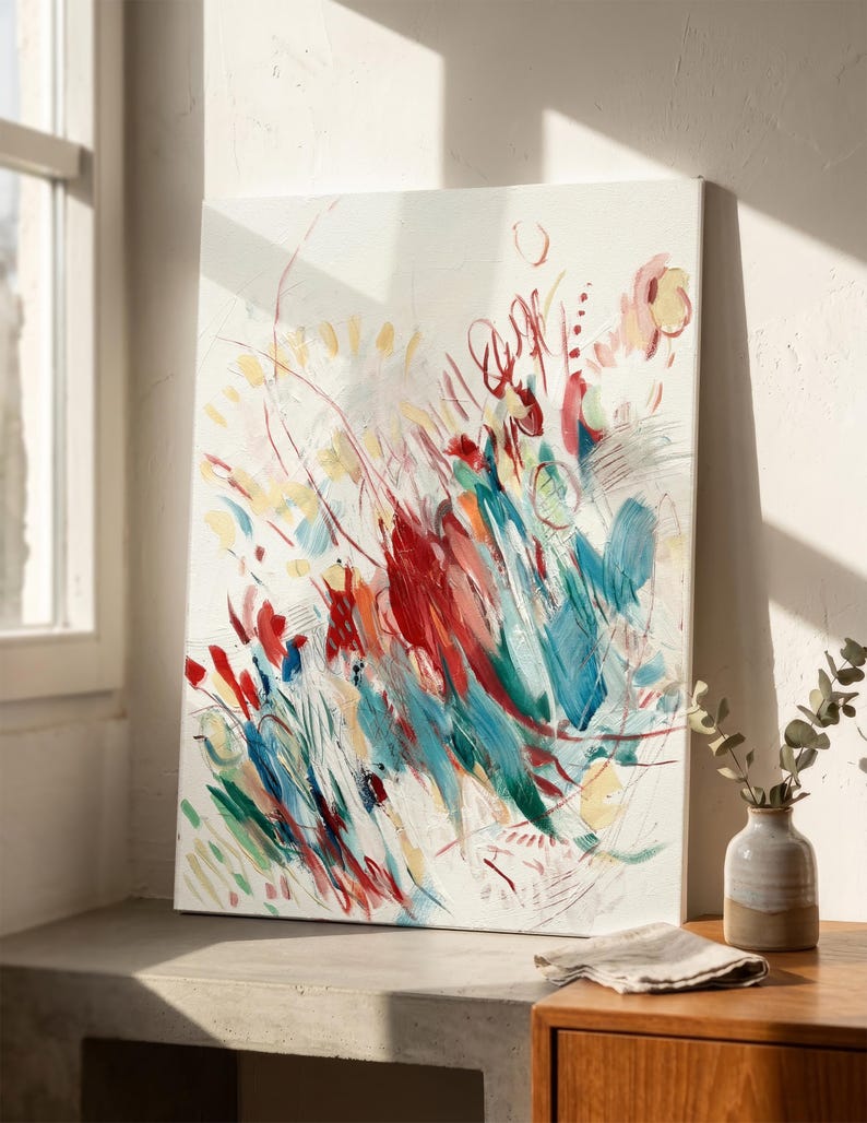 May include: A rectangular canvas painting featuring an abstract composition with energetic brushstrokes in vibrant red, deep teal, soft yellow, and white. The artwork displays layered paint textures, thin linear markings, and circular shapes across the surface.