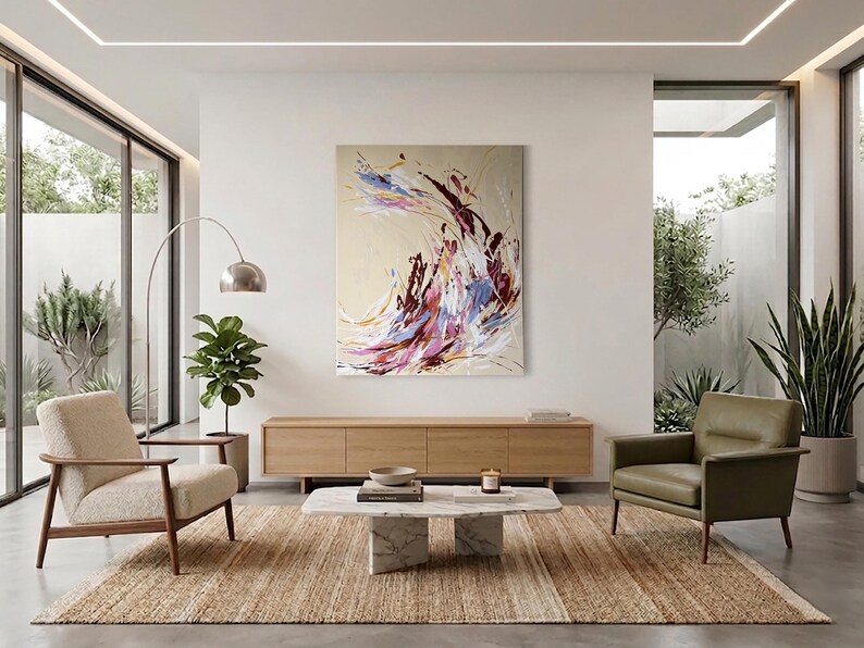 May include: A modern living room with a large abstract painting in shades of purple, blue, and red. The room features a light brown rug, two armchairs, a wooden cabinet, and a marble coffee table. A tall, arched lamp and potted plants add to the decor.