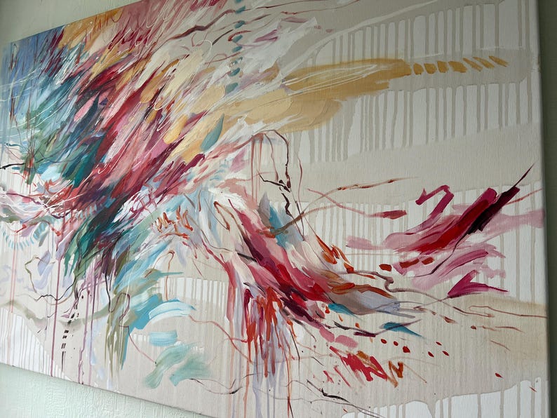 May include: Abstract canvas art featuring a dynamic composition of brushstrokes in shades of red, pink, teal, and gold. The artwork has a neutral background with vertical lines and drips, creating a sense of movement and depth. A modern piece for home decor.