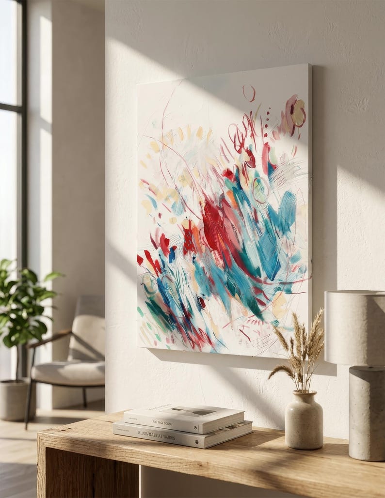 May include: A rectangular canvas painting featuring abstract brushstrokes in vibrant shades of red, teal, and yellow against a white background. The composition includes energetic lines, circular shapes, and layered paint textures.