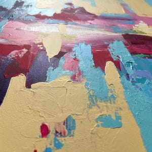 May include: Close-up of an abstract painting with thick brushstrokes. The artwork features a palette of colors including light blue, pink, purple, yellow, and red. The texture of the paint is visible, creating a dynamic and textured surface.
