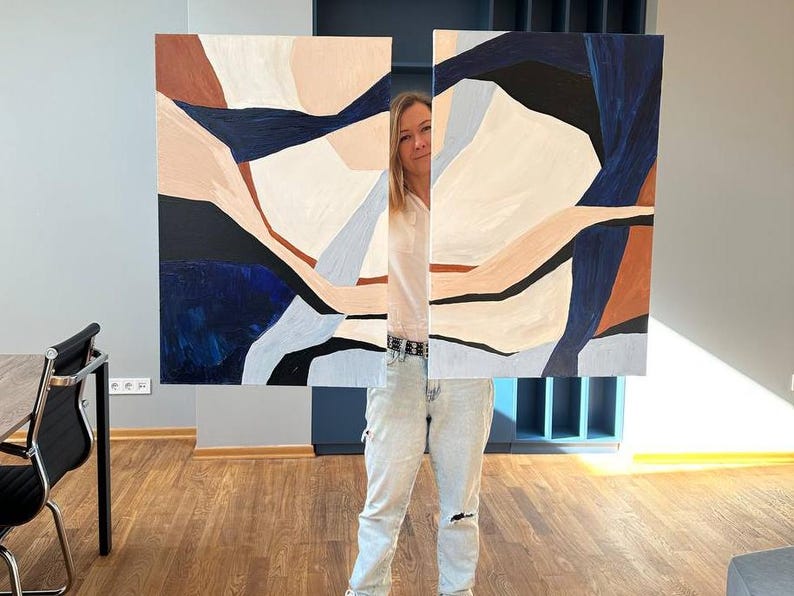 May include: Abstract art piece with a geometric design. The artwork features shapes in shades of navy blue, brown, black, and beige. The painting is displayed in two panels, creating a modern aesthetic.
