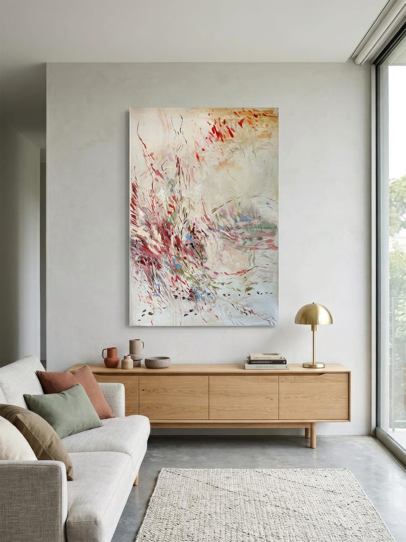 May include: A large vertical rectangular canvas painting featuring abstract brushstrokes in shades of crimson, deep red, soft beige, and muted green. The composition displays dynamic, flowing lines and scattered paint splatters across a light background.