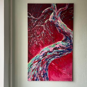 May include: An abstract painting of a tree against a red background. The tree trunk and branches are painted with strokes of blue, green, pink, and white. The artwork is displayed on a rectangular canvas.