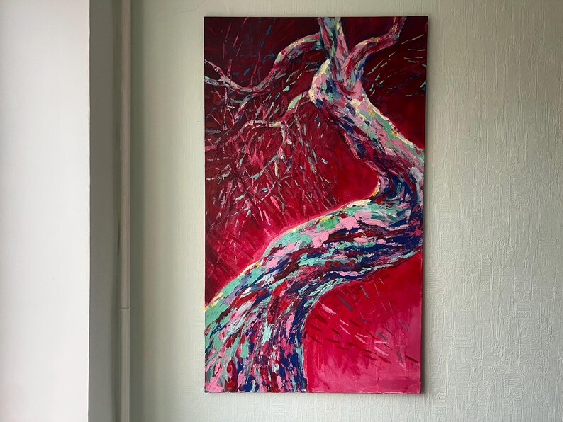 May include: An abstract painting of a tree against a red background. The tree trunk and branches are painted with strokes of blue, green, pink, and white. The artwork is displayed on a rectangular canvas.