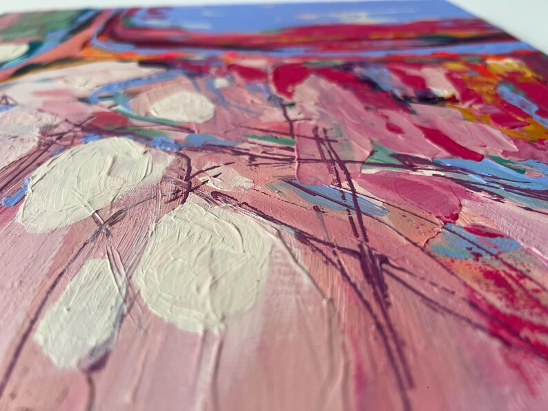 May include: Abstract painting with thick brushstrokes in shades of pink, white, blue, and red. The artwork features a textured surface with visible paint layers, creating a dynamic and expressive composition. The painting evokes a sense of movement and depth.