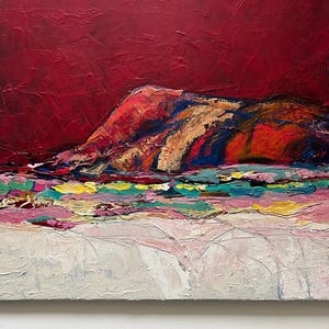 May include: Abstract landscape painting with a textured surface. The artwork features a deep red sky above a colorful mountain range with shades of orange, blue, and gold. The foreground has a mix of pink, green, and white brushstrokes.