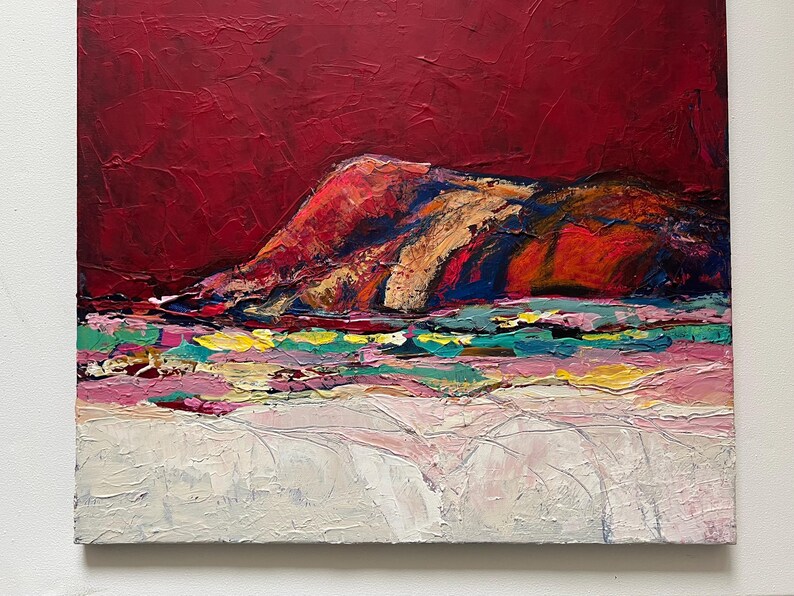 May include: Abstract landscape painting with a textured surface. The artwork features a deep red sky above a colorful mountain range with shades of orange, blue, and gold. The foreground has a mix of pink, green, and white brushstrokes.