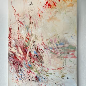 May include: A rectangular canvas painting featuring an abstract composition with a cream-colored background. The artwork displays dynamic, sweeping brushstrokes in shades of vibrant red, soft pink, muted green, and bright blue, creating a sense of movement.