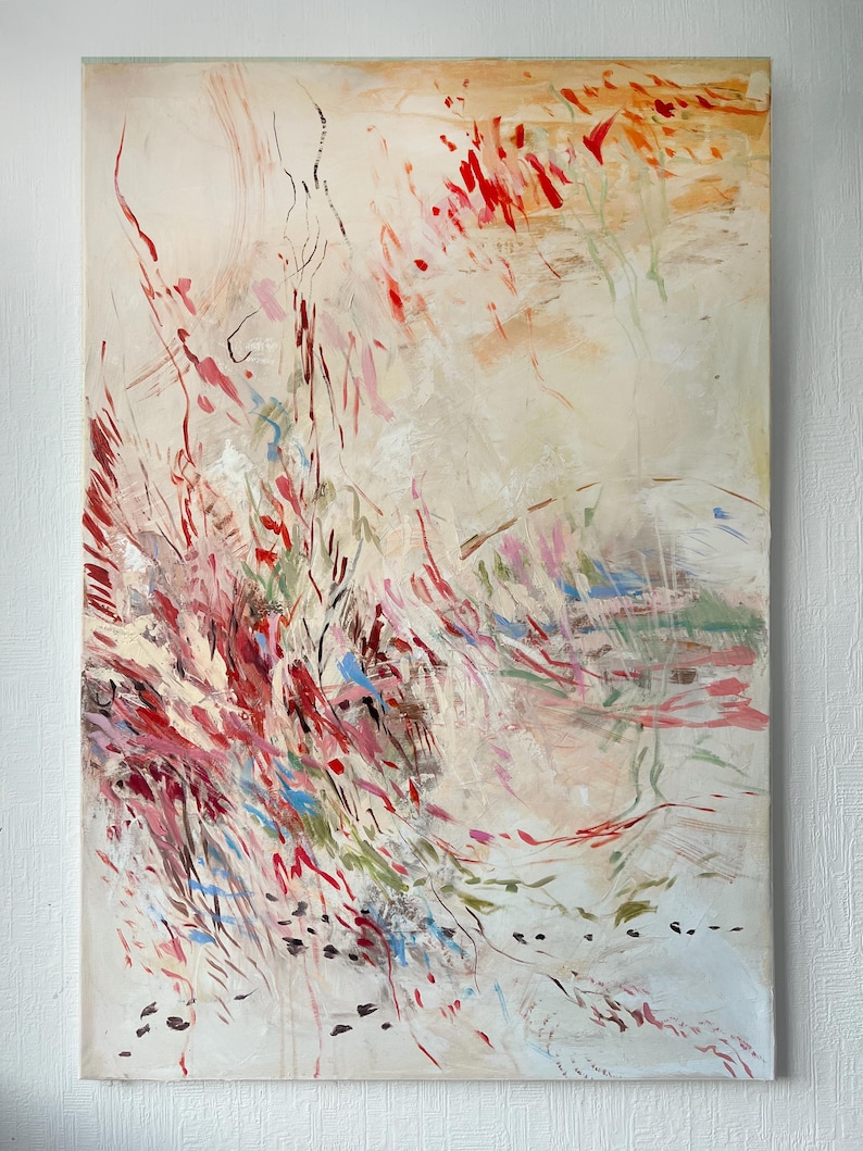 May include: A rectangular canvas painting featuring an abstract composition with a cream-colored background. The artwork displays dynamic, sweeping brushstrokes in shades of vibrant red, soft pink, muted green, and bright blue, creating a sense of movement.